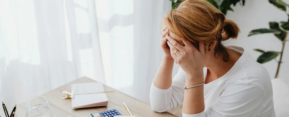 Australian homeowner reviewing mortgage statement at home desk with calculator and coffee