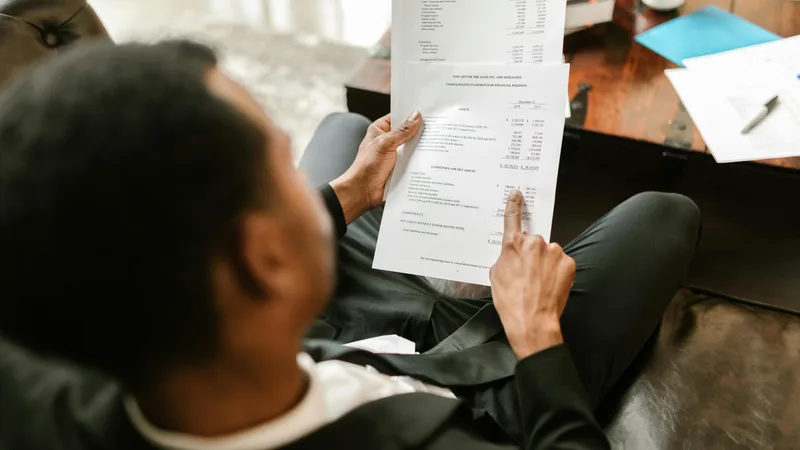 Australian investor on the phone with their tax accountant reviewing investment property documents before Federal Budget deadline