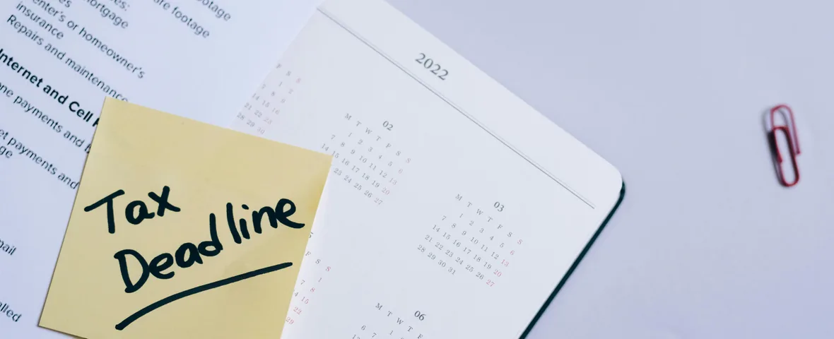 Australian property investor reviewing capital gains tax documents with a calendar showing May 12 Federal Budget deadline