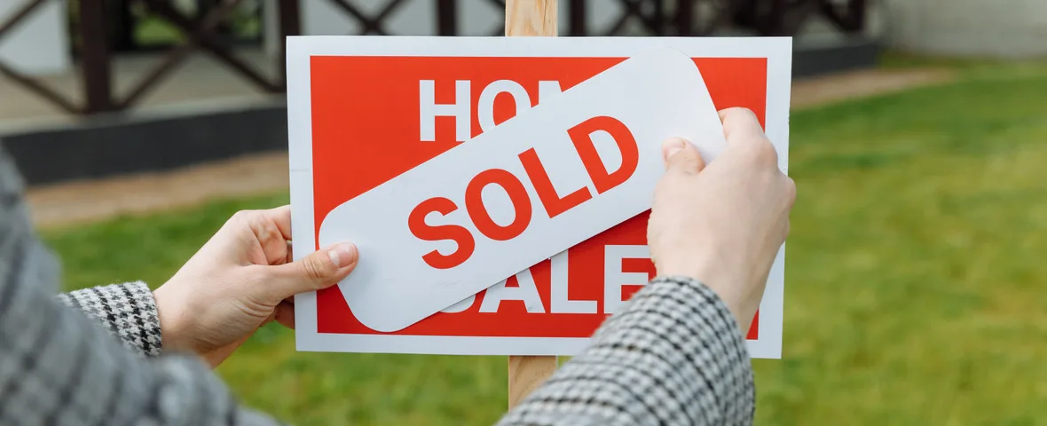 Sold sign outside an Australian house, where the real cost of the sale runs far beyond the agent's commission