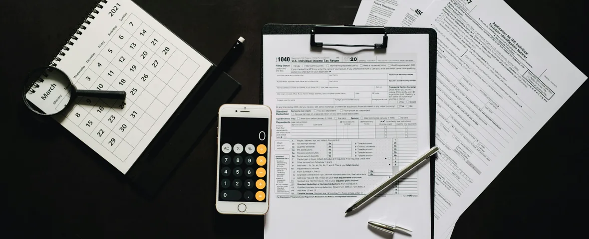 Open calendar showing June 30 deadline surrounded by tax documents, calculator and laptop on Australian home office desk