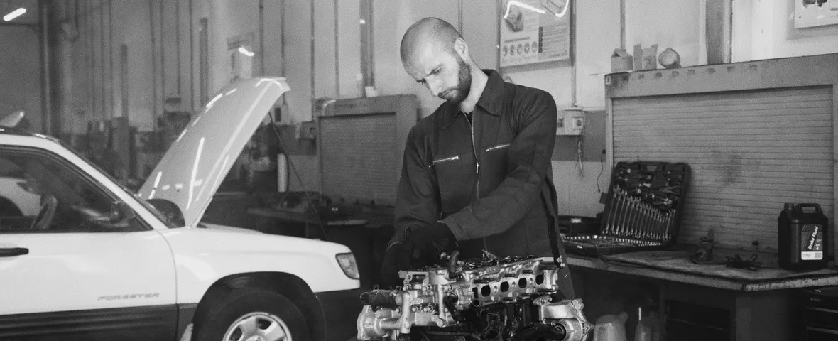 Mechanic discussing a repair quote with a car owner in an Australian workshop