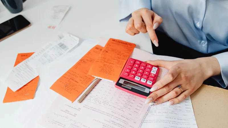 Receipts and expense records sorted with calculator before claiming tax deductions in myTax