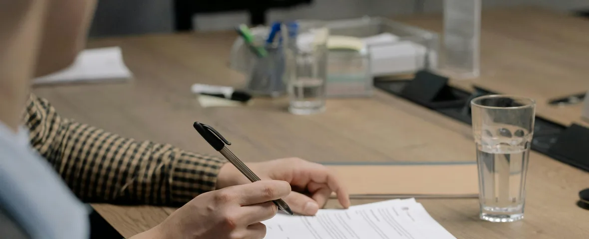 Two Australian property investors signing contracts at different times on 12 May 2026 with calculator and contract paperwork