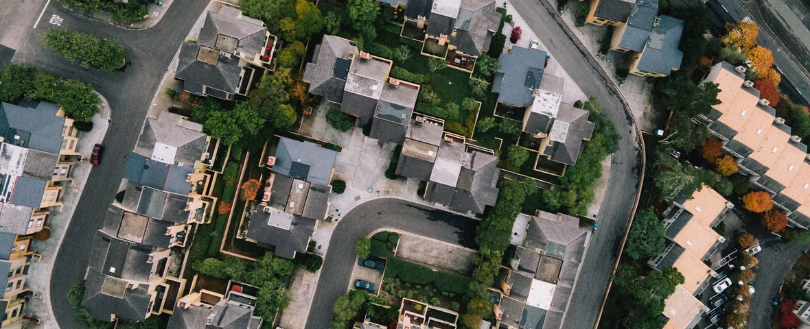 Aerial view of a suburban street of family homes, the kind of school catchment address buyers pay a premium for
